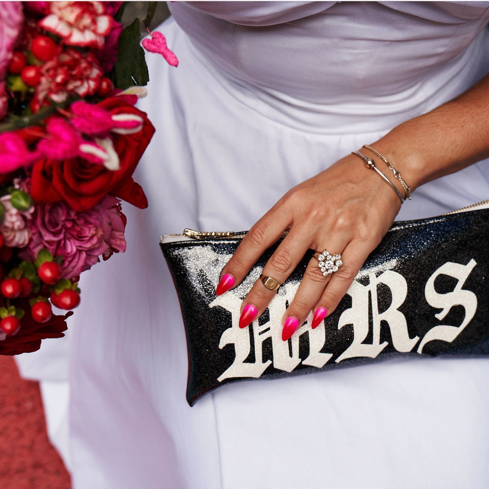 Wedding day with custom mrs clutch and engagement ring red and pink flowers