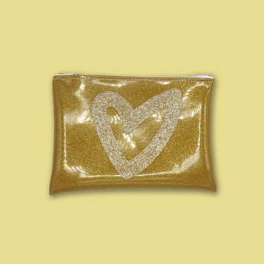 gold heart glitter vinyl clutch on gold background