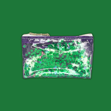 clear purple vinyl bag filled with 420 friendly confetti keychain clutch cosmetic clutch by julie mollo and kush kards green confetti and green background