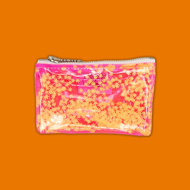 clear pink vinyl bag filled with 420 friendly confetti keychain clutch cosmetic clutch by julie mollo and kush kards orange confetti and orange background