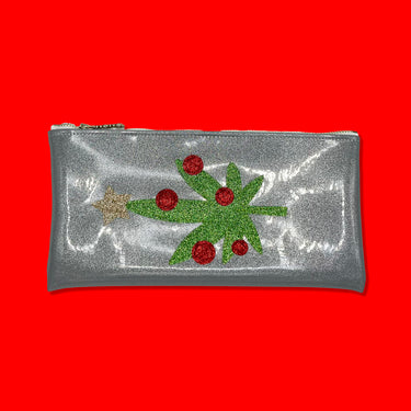 Silver glitter infused vinyl clutch with a cute and sparkly cannabis leaf as a Christmas tree, adorned with red ornaments and a gold star on top. Clutch is featured on a red background.