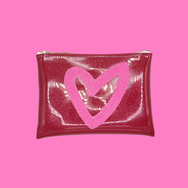 pink heart and arrow glitter vinyl clutch on pink background